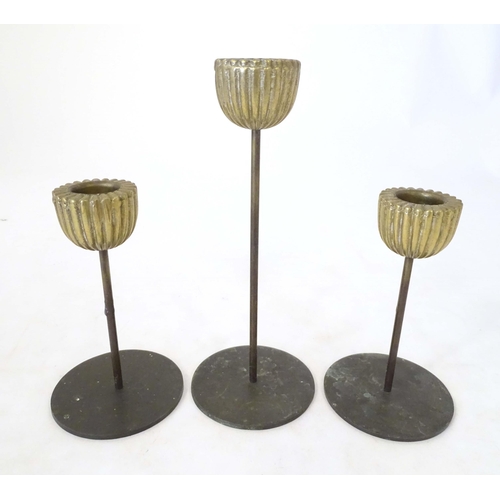 1259 - Three mid century modernist candlesticks, the reeded brass sconces on a cylindrical stem on a circul... 