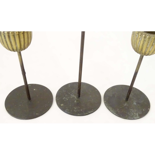 1259 - Three mid century modernist candlesticks, the reeded brass sconces on a cylindrical stem on a circul... 