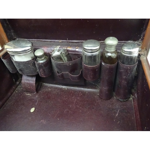 1263 - A mid 20thC vanity case, with fitted interior containing bottles, together with a mid 20thC small su... 