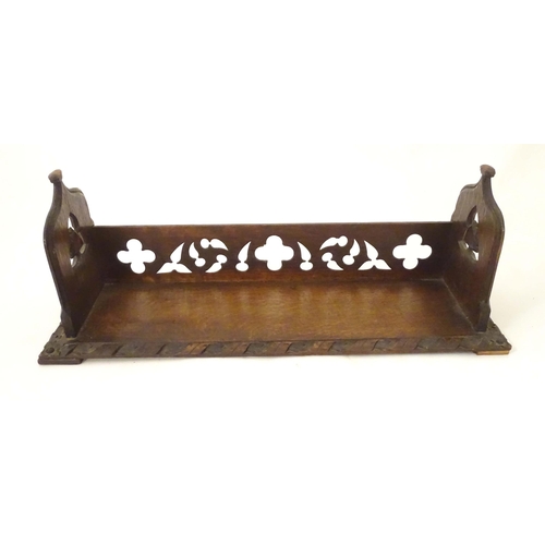 1264 - A 19thC carved oak Gothic book trough with lancet shaped uprights and carved foliate detail. Label u... 