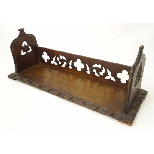 1264 - A 19thC carved oak Gothic book trough with lancet shaped uprights and carved foliate detail. Label u... 