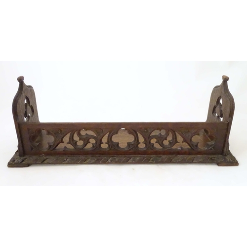 1264 - A 19thC carved oak Gothic book trough with lancet shaped uprights and carved foliate detail. Label u... 