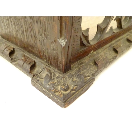 1264 - A 19thC carved oak Gothic book trough with lancet shaped uprights and carved foliate detail. Label u... 