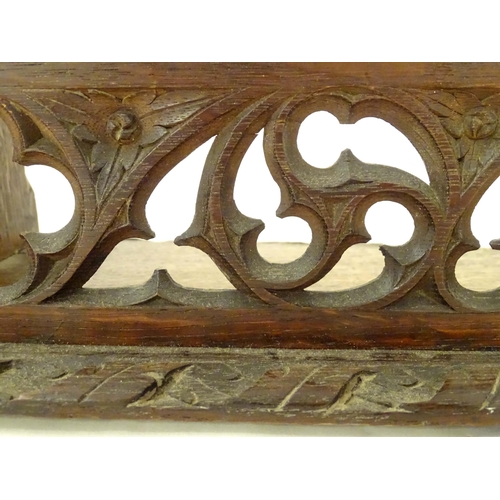 1264 - A 19thC carved oak Gothic book trough with lancet shaped uprights and carved foliate detail. Label u... 