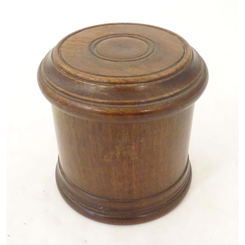 1265 - An early 20thC turned mahogany treen box and cover / container of cylindrical form with banded decor... 