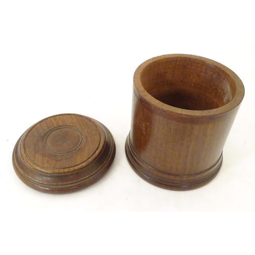 1265 - An early 20thC turned mahogany treen box and cover / container of cylindrical form with banded decor... 