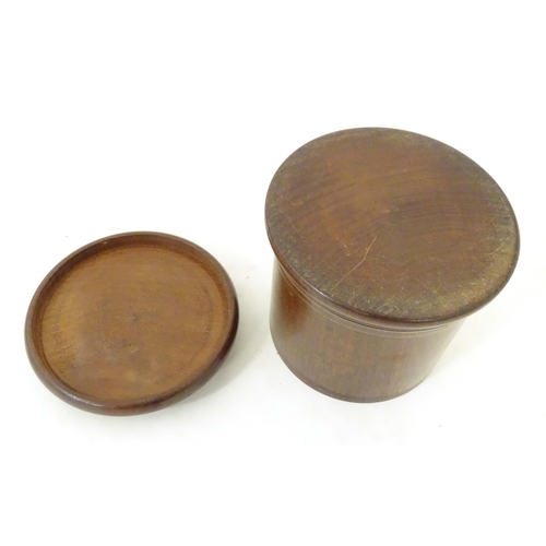 1265 - An early 20thC turned mahogany treen box and cover / container of cylindrical form with banded decor... 