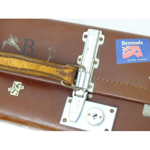 1267 - A mid 20thC 'Revelation' suitcase, with affixed transit labels, together with a small leather suitca... 