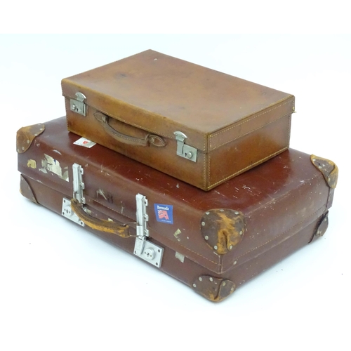 1267 - A mid 20thC 'Revelation' suitcase, with affixed transit labels, together with a small leather suitca... 