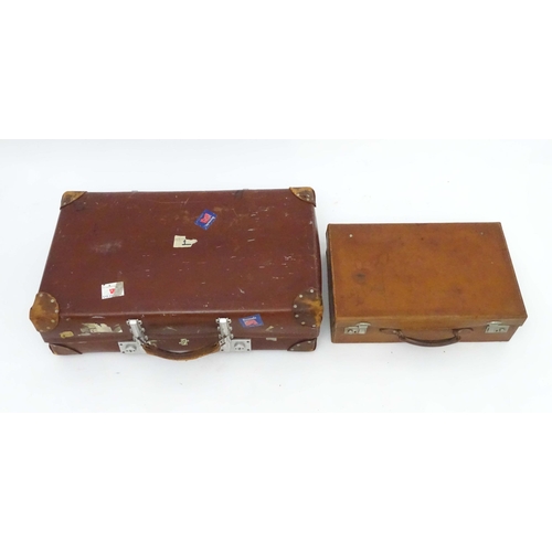 1267 - A mid 20thC 'Revelation' suitcase, with affixed transit labels, together with a small leather suitca... 