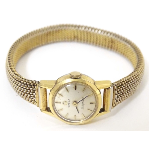 765 - A mid 20thC Omega 'Ladymatic' wrist watch, together with a ladies' 9ct gold cased wrist watch by Maj... 