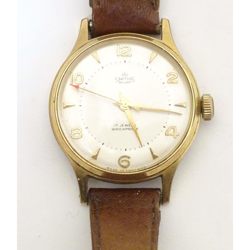 766 - A mid 20thC wrist watch by Smiths , de luxe model A456 , fitted with a leather strap.