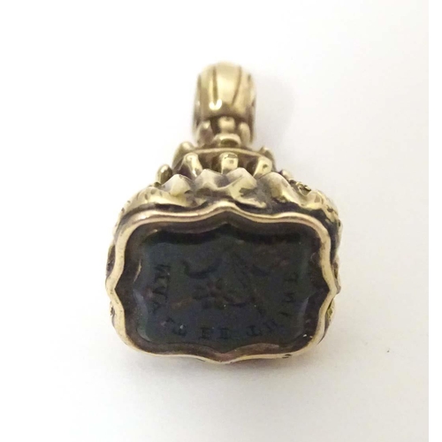 790 - A 19thC yellow metal pendant fob seal set with bloodstone seal under titled May It Be Thine. Approx.... 