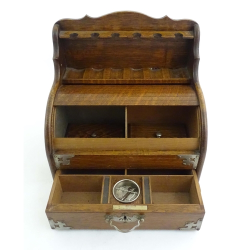 1066 - An early 20thC oak smokers companion / box with silver plate mounts, tambour front with a single fit... 