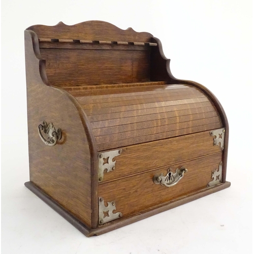 1066 - An early 20thC oak smokers companion / box with silver plate mounts, tambour front with a single fit... 