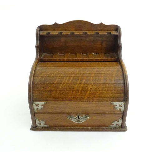 1066 - An early 20thC oak smokers companion / box with silver plate mounts, tambour front with a single fit... 