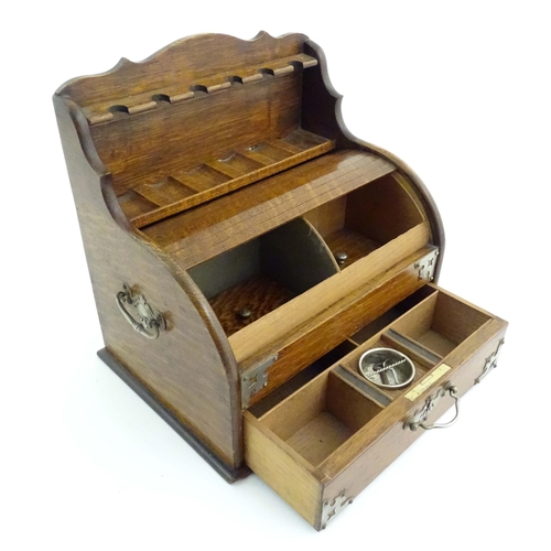 1066 - An early 20thC oak smokers companion / box with silver plate mounts, tambour front with a single fit... 