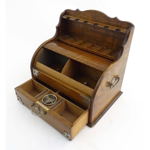 1066 - An early 20thC oak smokers companion / box with silver plate mounts, tambour front with a single fit... 