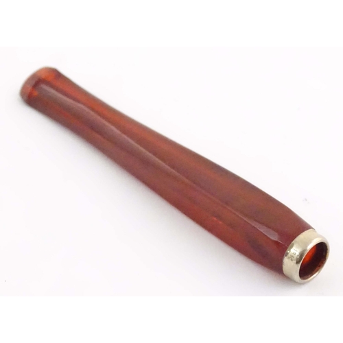 1070 - An Art Deco amber coloured cheroot holder with white metal mount. Approx. 4