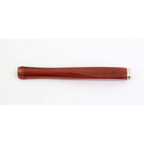 1070 - An Art Deco amber coloured cheroot holder with white metal mount. Approx. 4