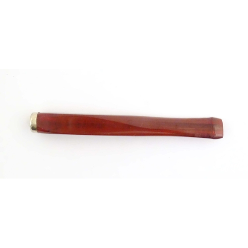 1070 - An Art Deco amber coloured cheroot holder with white metal mount. Approx. 4