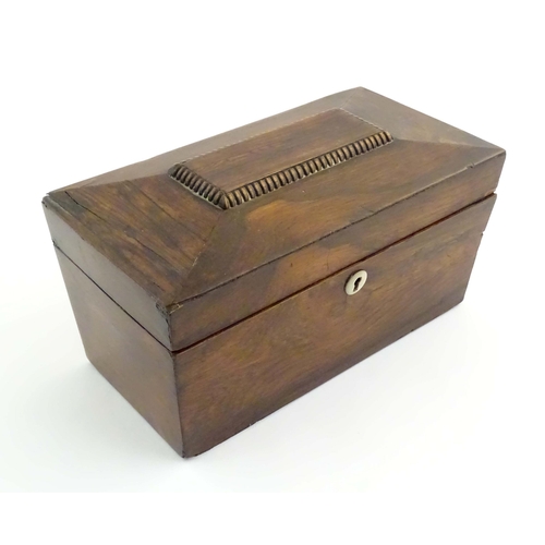 1074 - A 19thC mahogany tea caddy of sarcophagus form with mother of pearl escutcheon. The fitted interior ... 