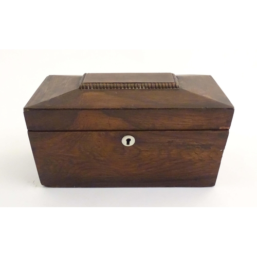 1074 - A 19thC mahogany tea caddy of sarcophagus form with mother of pearl escutcheon. The fitted interior ... 