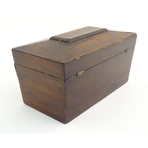 1074 - A 19thC mahogany tea caddy of sarcophagus form with mother of pearl escutcheon. The fitted interior ... 