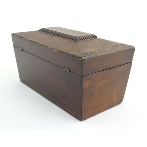 1074 - A 19thC mahogany tea caddy of sarcophagus form with mother of pearl escutcheon. The fitted interior ... 