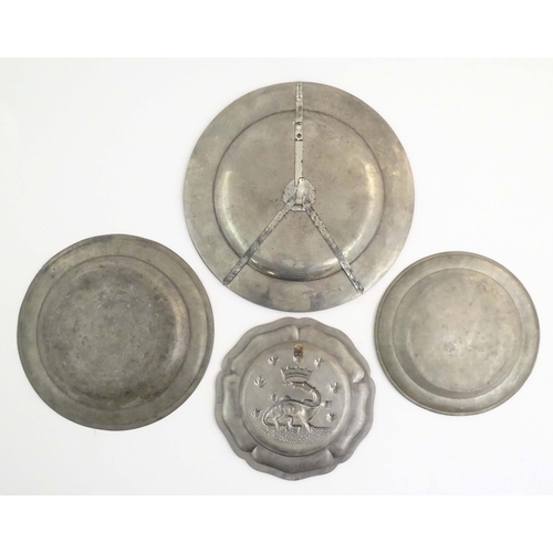 1111 - Four assorted pewter plates, comprising a 20thC Les Etains du Manoir plate decorated with heraldic d... 