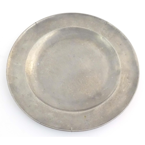 1111 - Four assorted pewter plates, comprising a 20thC Les Etains du Manoir plate decorated with heraldic d... 