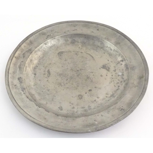 1111 - Four assorted pewter plates, comprising a 20thC Les Etains du Manoir plate decorated with heraldic d... 