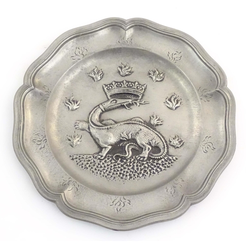 1111 - Four assorted pewter plates, comprising a 20thC Les Etains du Manoir plate decorated with heraldic d... 