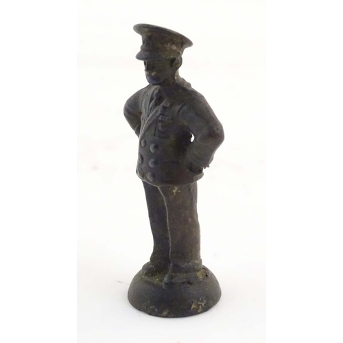 1135 - A late 19th / early 20thC cast copper pipe tamper modelled as an officer figure. Approx. 2 1/2