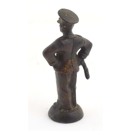 1135 - A late 19th / early 20thC cast copper pipe tamper modelled as an officer figure. Approx. 2 1/2