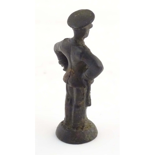 1135 - A late 19th / early 20thC cast copper pipe tamper modelled as an officer figure. Approx. 2 1/2