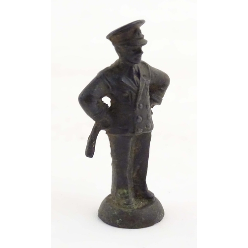 1135 - A late 19th / early 20thC cast copper pipe tamper modelled as an officer figure. Approx. 2 1/2