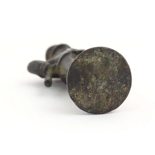 1135 - A late 19th / early 20thC cast copper pipe tamper modelled as an officer figure. Approx. 2 1/2