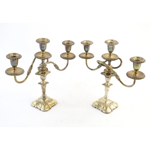 552 - A pair of silver plate candlesticks by Barker Ellis with associated silver plate three branch sconce... 