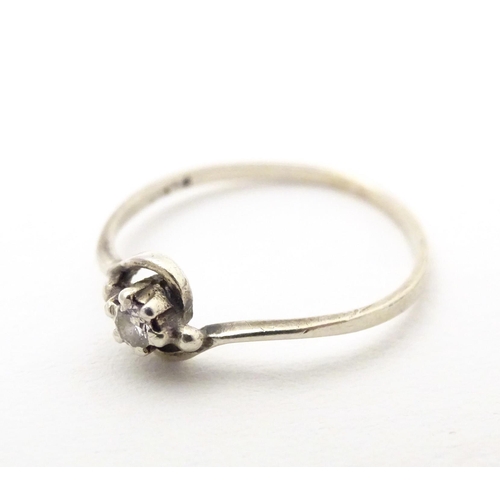 575 - A diamond solitaire ring in a platinum setting. Ring size approx. O