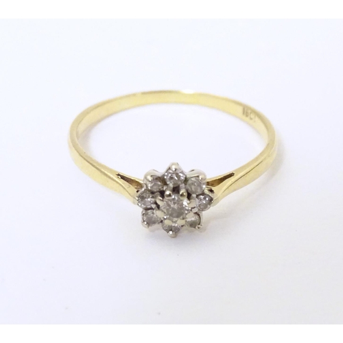 580 - A 18ct gold ring set with diamond cluster to top. Ring size approx. Q 1/2