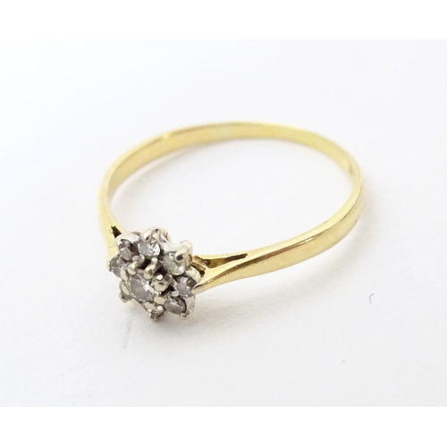 580 - A 18ct gold ring set with diamond cluster to top. Ring size approx. Q 1/2