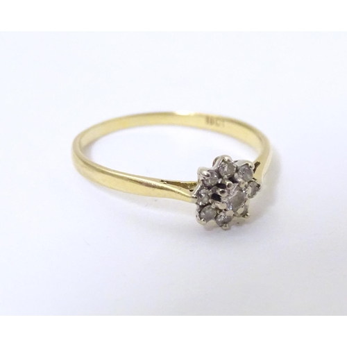 580 - A 18ct gold ring set with diamond cluster to top. Ring size approx. Q 1/2