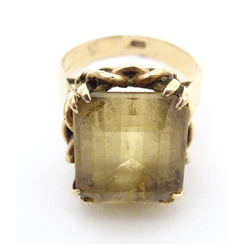 584 - A 9ct gold dress ring set with citrine. Ring size approx. P 1/2