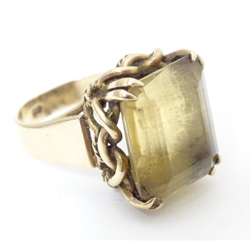 584 - A 9ct gold dress ring set with citrine. Ring size approx. P 1/2