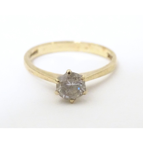 588 - A 9ct gold ring set with white stone solitaire. Ring size approx. N