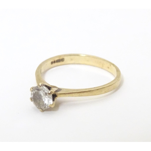 588 - A 9ct gold ring set with white stone solitaire. Ring size approx. N