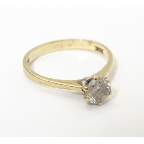 588 - A 9ct gold ring set with white stone solitaire. Ring size approx. N