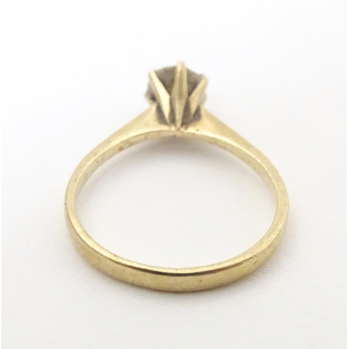 588 - A 9ct gold ring set with white stone solitaire. Ring size approx. N