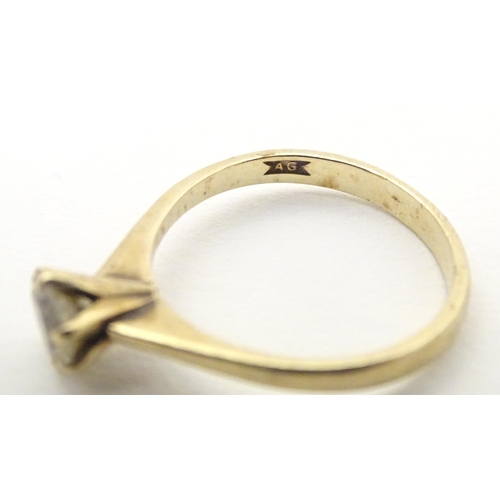 588 - A 9ct gold ring set with white stone solitaire. Ring size approx. N